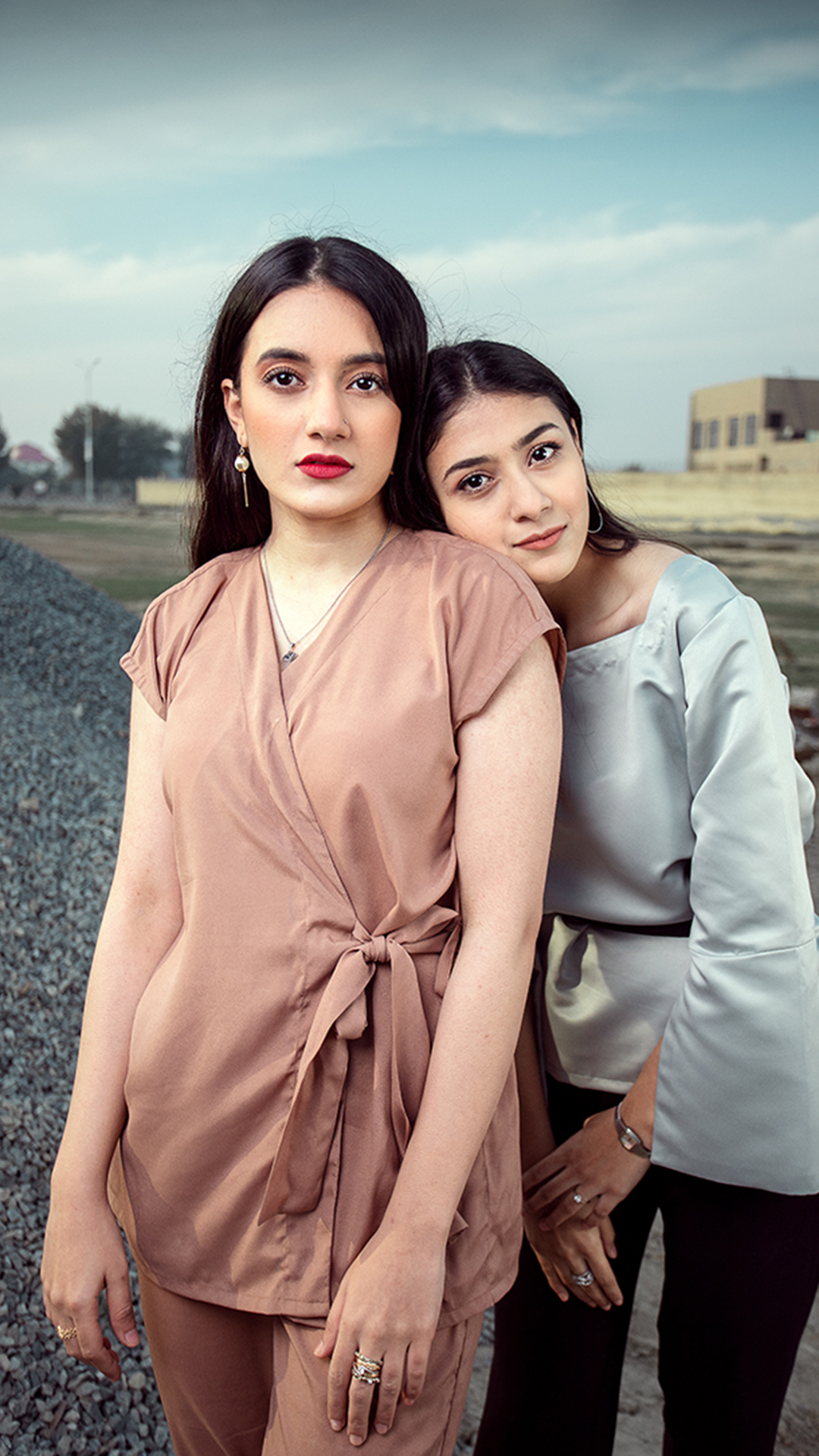 two girls wearing belted peplum blouses